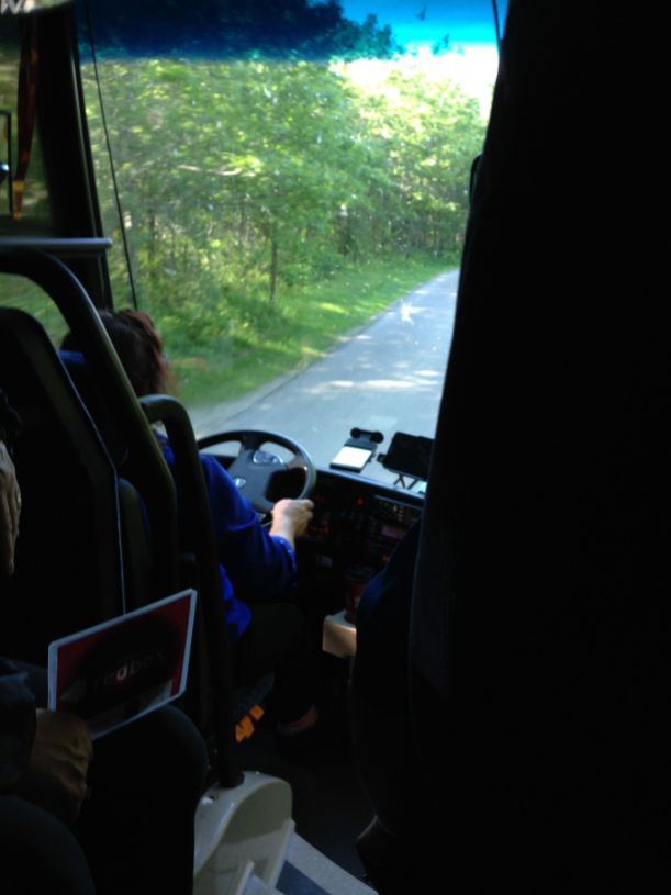 A staff member rides along behind the driver to manage kids and paperwork