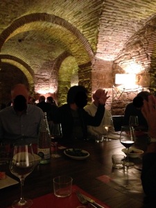 People seated in beneath stone arches in Barcelona restaurant