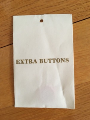 Paper envelope hang tag containing Extra Buttons