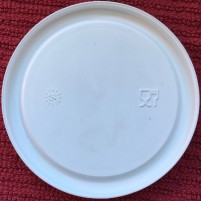 Weck canning jar lid in plastic, underside, shows dishwasher safe symbol