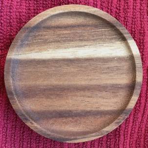 Weck canning jar lid in wood, top view