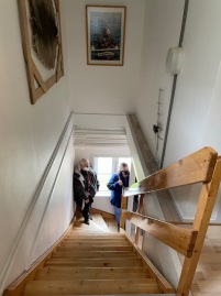13 of the 16 wooden steps visible in this shot down the stairwell